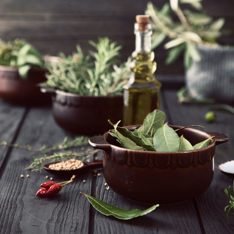 A rooftop deck with chairs and a small shed on